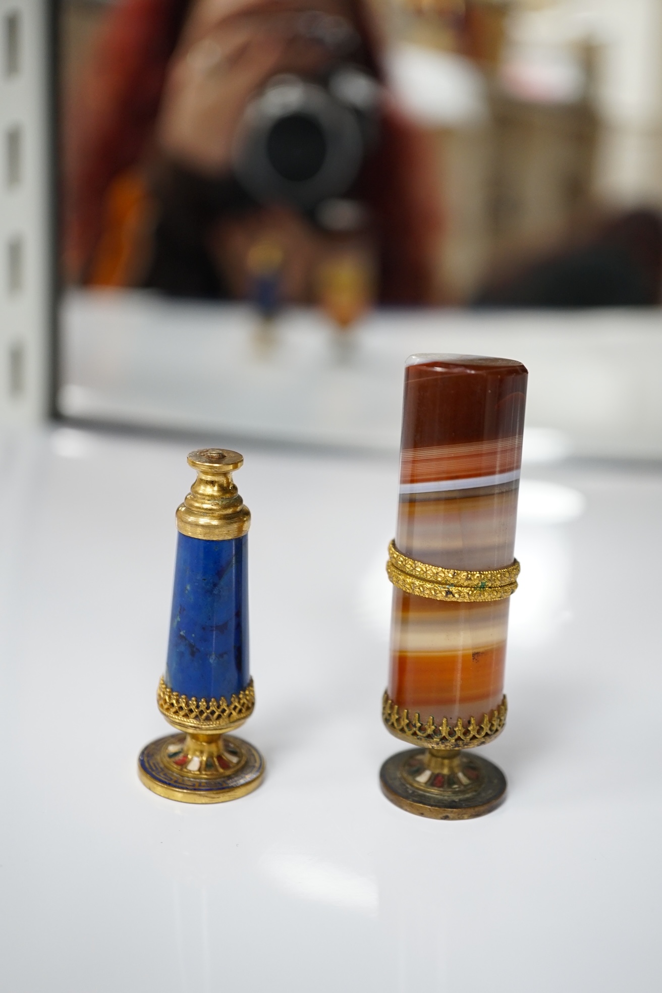 A 19th century agate and gilt metal table seal with gilt snake decoration and a smaller lapis lazuli seal, tallest agate seal 7cm high (2). Condition - fair